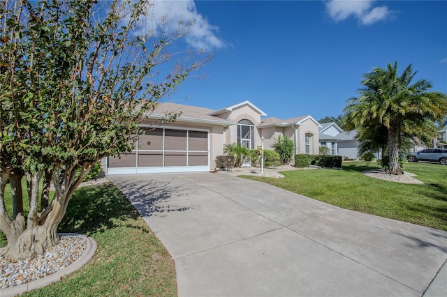 ranch-style home featuring a front lawn and a garage