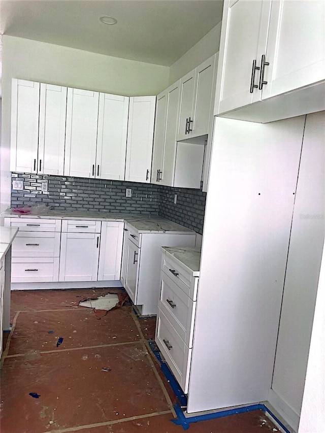 kitchen with white cabinets and backsplash