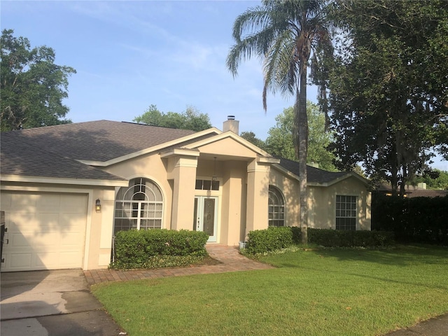 ranch-style house with a garage and a front lawn