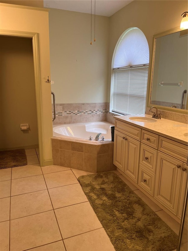 bathroom featuring vanity, tiled bath, and tile patterned floors