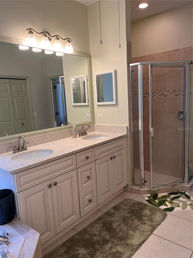 bathroom featuring tile patterned floors, vanity, and an enclosed shower