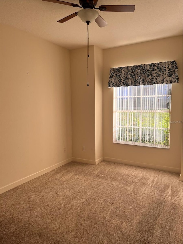 carpeted empty room with ceiling fan