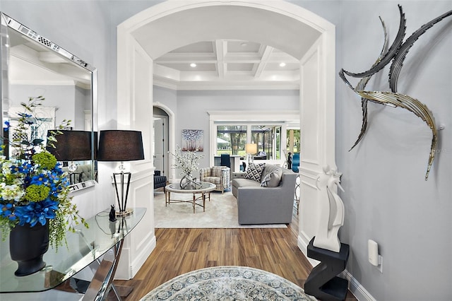 living room featuring beamed ceiling, coffered ceiling, and wood-type flooring