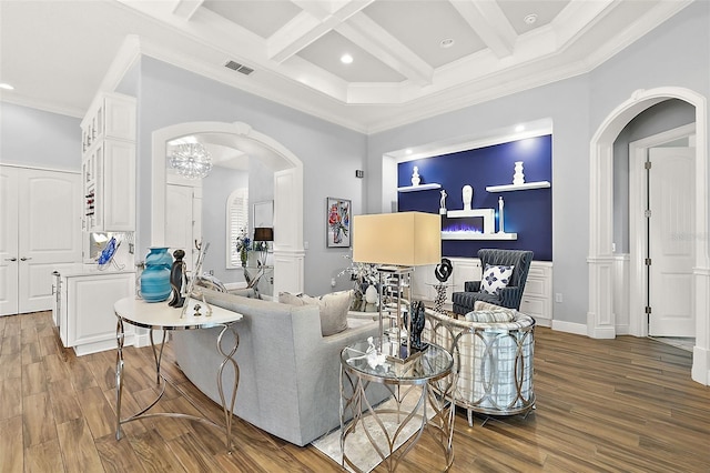 living room featuring ornamental molding, coffered ceiling, and hardwood / wood-style flooring