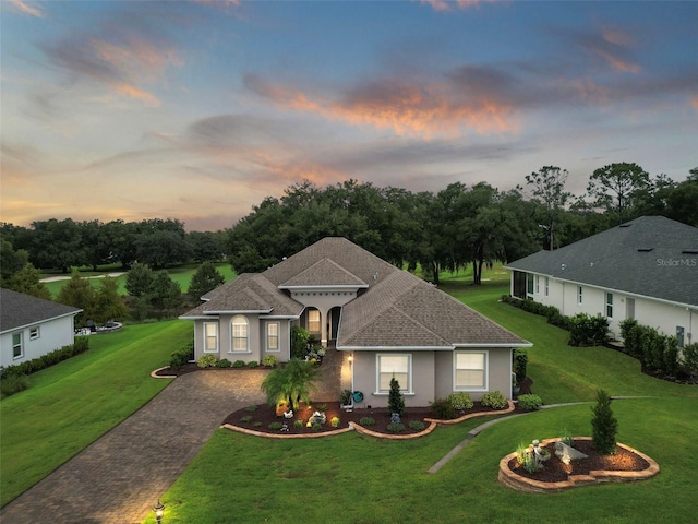 ranch-style home with a yard