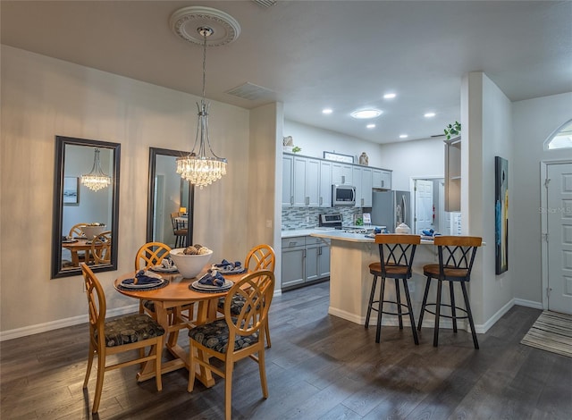 dining room featuring dark hardwood / wood-style floors and a chandelier