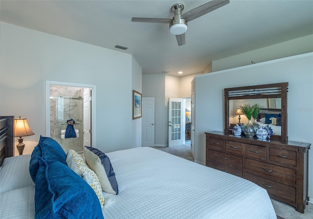 carpeted bedroom with ceiling fan and ensuite bath