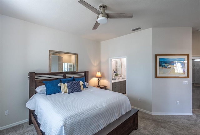 bedroom with carpet flooring, ceiling fan, and ensuite bath