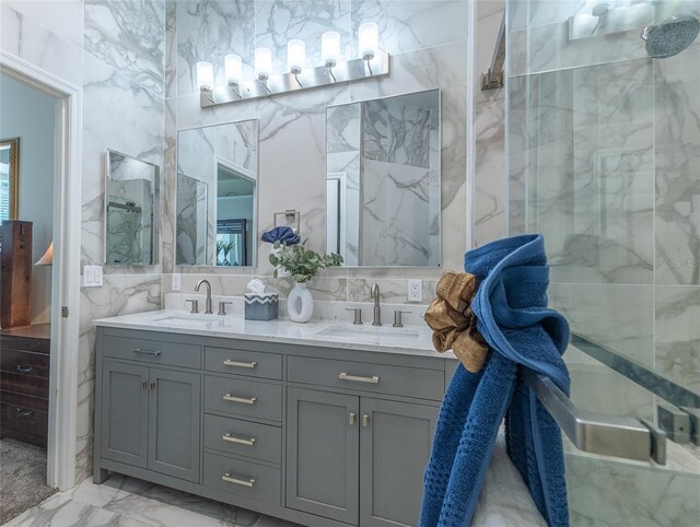 bathroom with an enclosed shower, vanity, tile walls, and backsplash