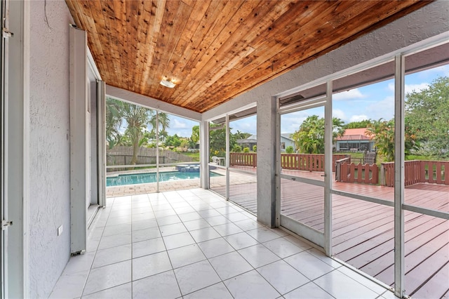 unfurnished sunroom featuring lofted ceiling and wood ceiling