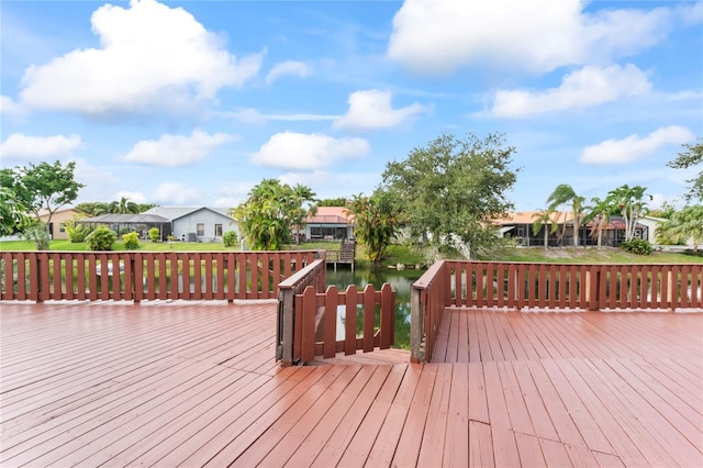 wooden deck featuring a water view