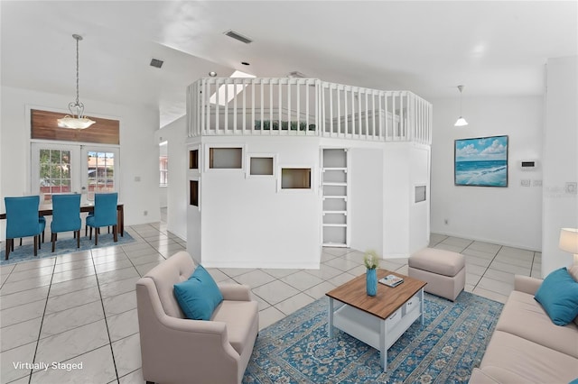 living room featuring lofted ceiling, french doors, and light tile patterned floors