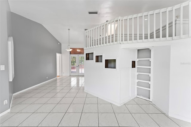 interior space with french doors and high vaulted ceiling