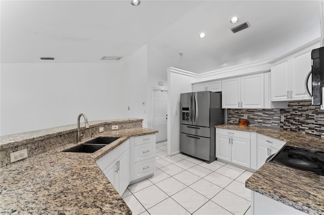 kitchen with appliances with stainless steel finishes, sink, decorative backsplash, and white cabinets