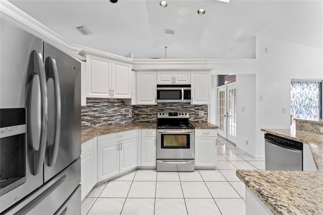 kitchen with white cabinetry, stainless steel appliances, lofted ceiling, and a wealth of natural light