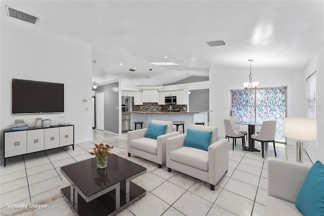 living room featuring lofted ceiling, a notable chandelier, and light tile patterned floors