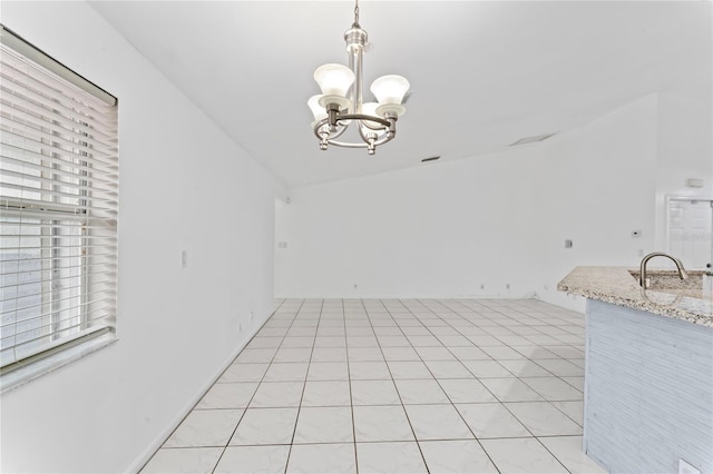 unfurnished dining area with a notable chandelier, light tile patterned flooring, and lofted ceiling