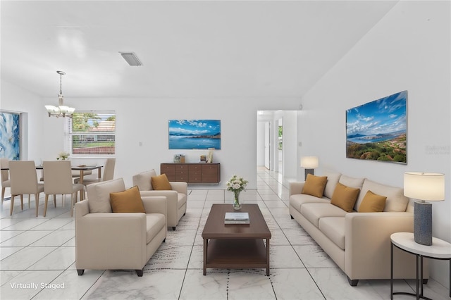 living room with lofted ceiling and a chandelier