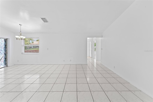 unfurnished room with a notable chandelier and light tile patterned floors