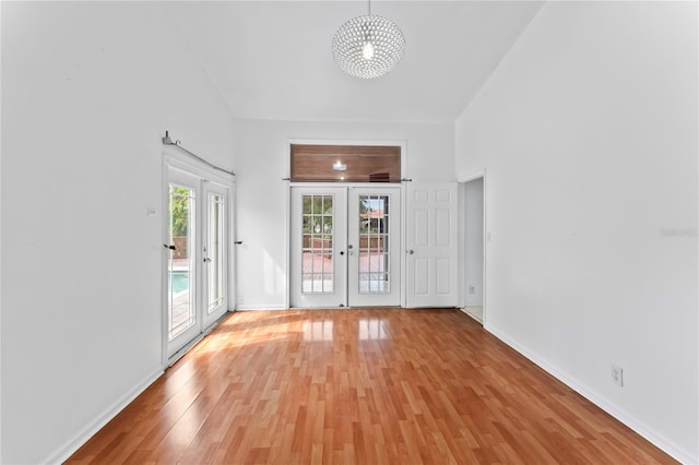 interior space with french doors and light wood-type flooring