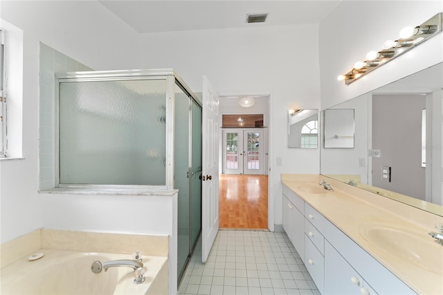 bathroom featuring vanity, hardwood / wood-style flooring, and shower with separate bathtub