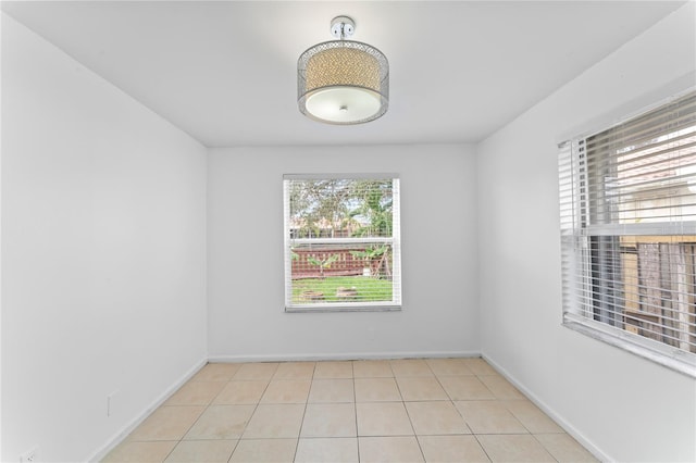 tiled spare room with plenty of natural light