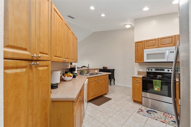 kitchen with sink, vaulted ceiling, stainless steel range with electric stovetop, and light tile patterned floors