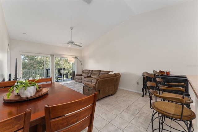 dining space featuring ceiling fan, vaulted ceiling, and light tile patterned floors