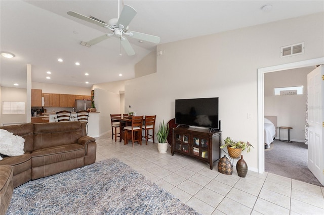 tiled living room with ceiling fan and lofted ceiling