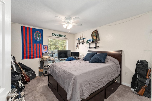 carpeted bedroom with ceiling fan and a textured ceiling