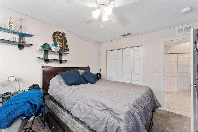 carpeted bedroom featuring a textured ceiling, a closet, and ceiling fan