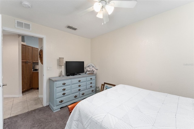 carpeted bedroom featuring a closet, ceiling fan, and a walk in closet