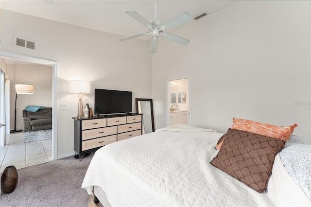 carpeted bedroom featuring ensuite bath, high vaulted ceiling, and ceiling fan