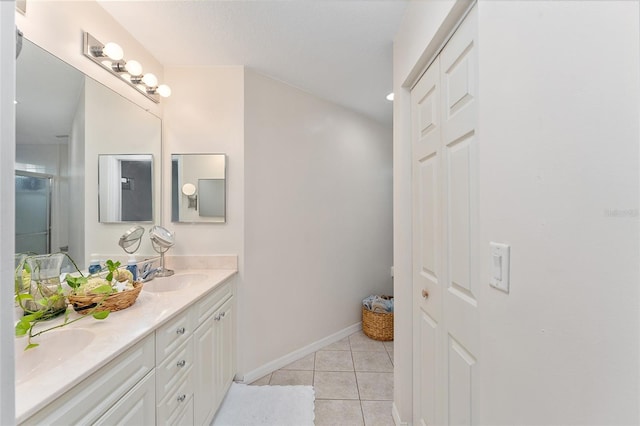 bathroom with vanity, tile patterned floors, and a shower with door