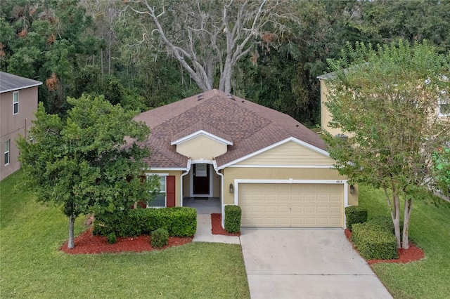 view of front facade featuring a front yard and a garage