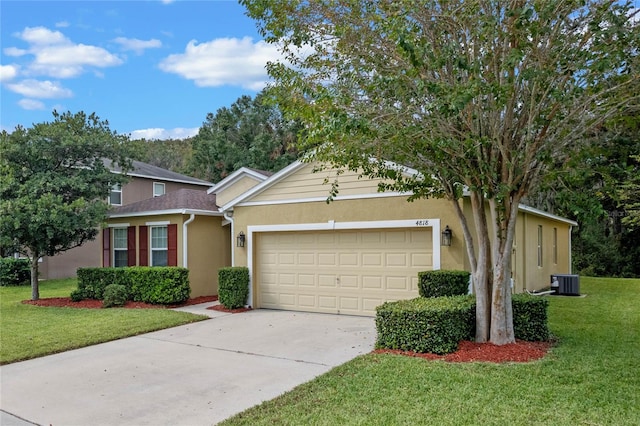 view of front of home featuring cooling unit, a garage, and a front lawn