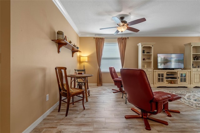 sitting room with ornamental molding, a textured ceiling, light wood-type flooring, and ceiling fan