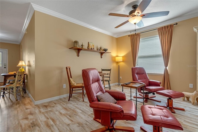 living area with ceiling fan, ornamental molding, a textured ceiling, and light wood-type flooring