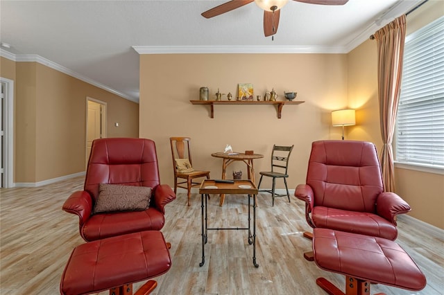 sitting room featuring light hardwood / wood-style floors, crown molding, a wealth of natural light, and ceiling fan