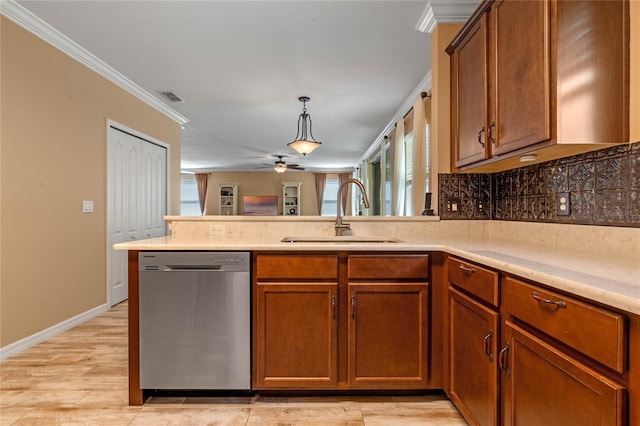 kitchen with dishwasher, hanging light fixtures, sink, crown molding, and light wood-type flooring