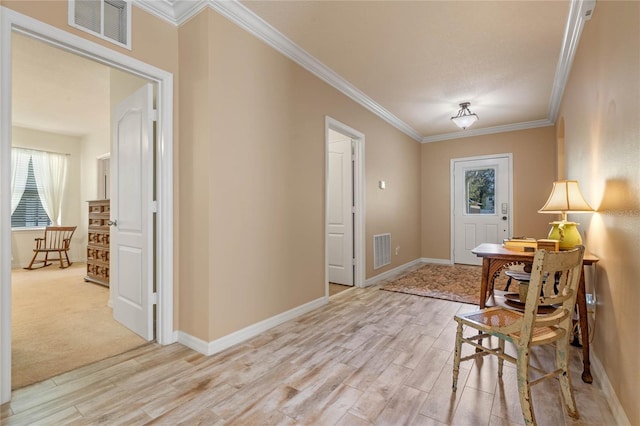 entryway with crown molding and light wood-type flooring