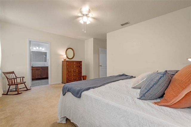 carpeted bedroom with connected bathroom and ceiling fan