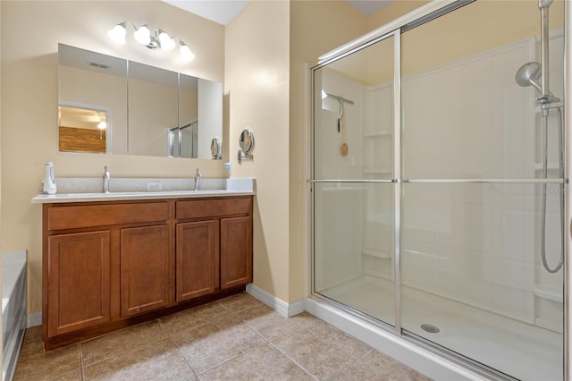 bathroom with vanity, tile patterned flooring, and an enclosed shower