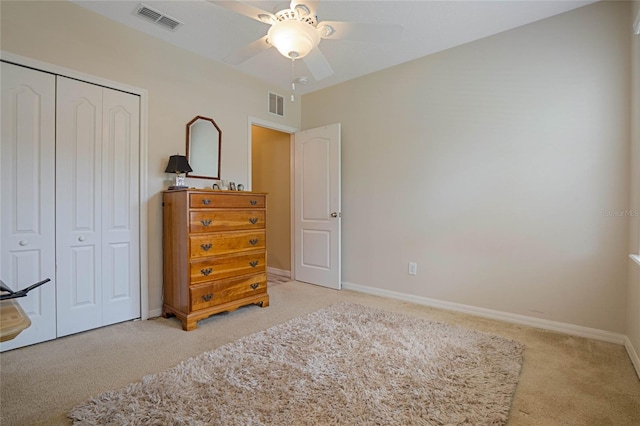 carpeted bedroom with a closet and ceiling fan