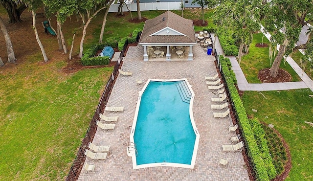 view of swimming pool with a yard and a patio