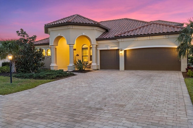 mediterranean / spanish house featuring a garage