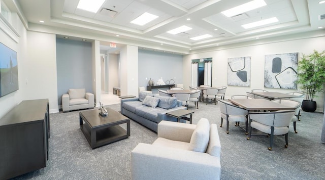 living room featuring coffered ceiling and carpet floors