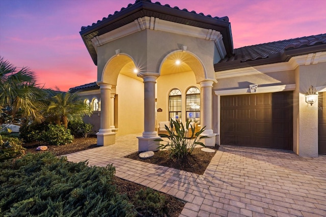 mediterranean / spanish house with a garage