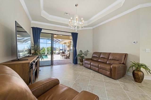 tiled living room featuring crown molding, a notable chandelier, and a raised ceiling