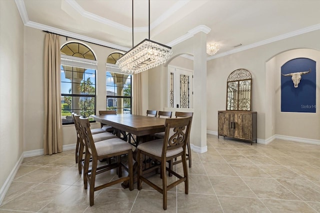 tiled dining space with crown molding and a chandelier